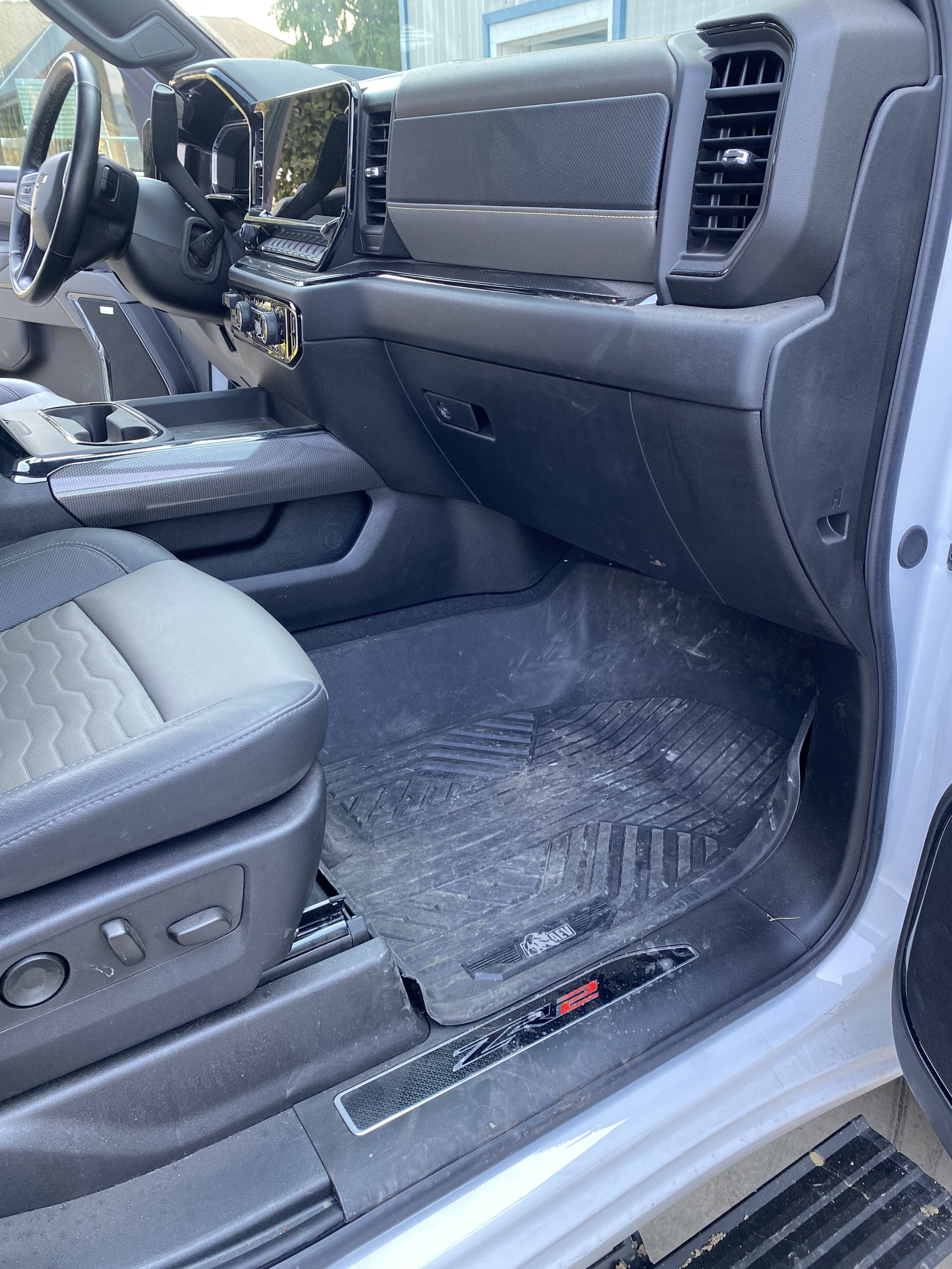 Truck front passenger mat before detailing with dirt and dust